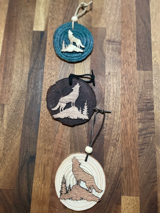 Wooden ornaments with wolf design on wooden rounds with leather string ties. Various stains and  colors.